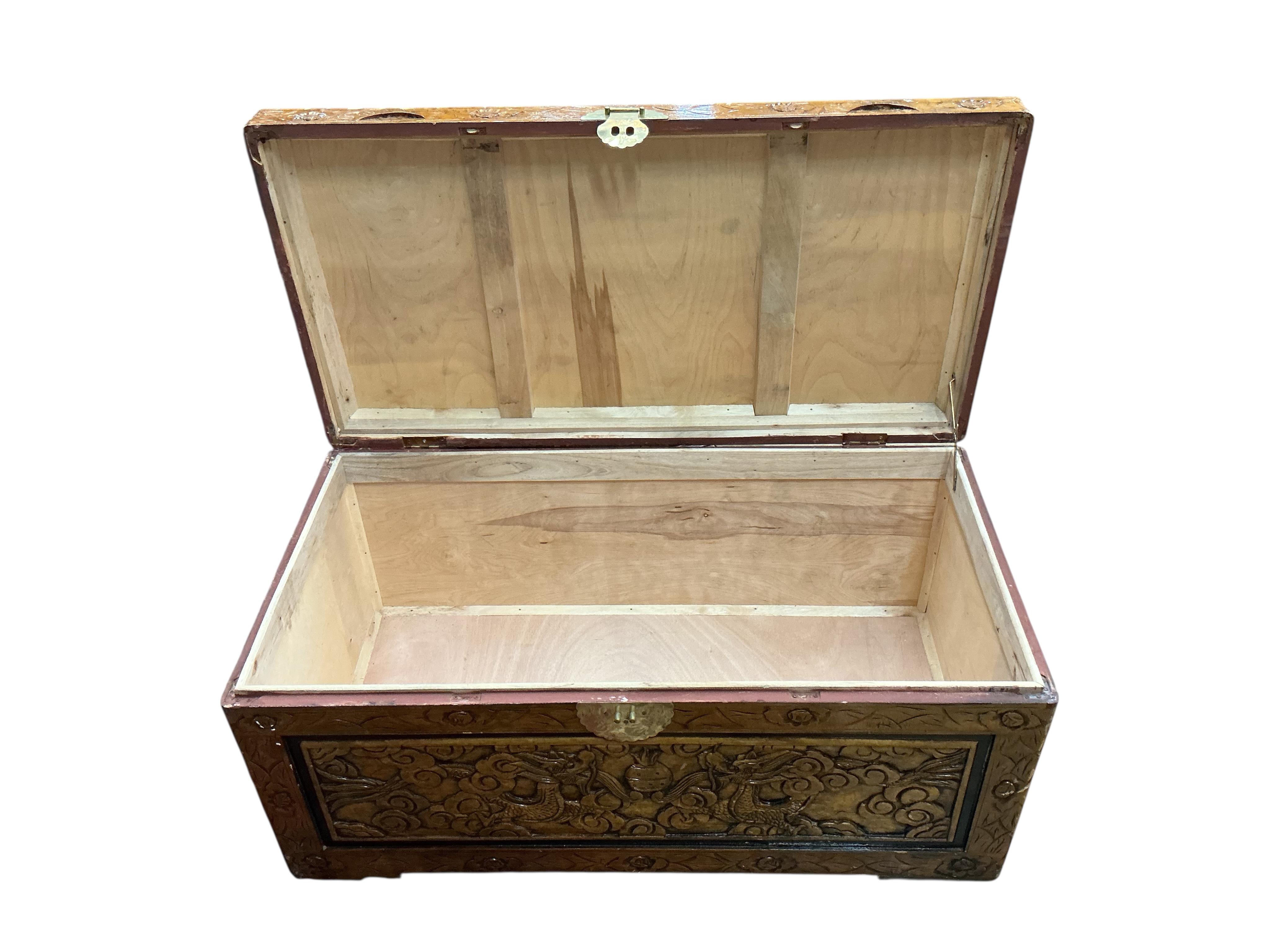 A Chinese carved camphorwood trunk, width 102cm, depth 51cm, height 45cm